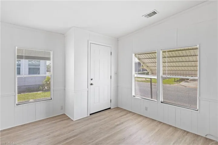 Inside the entryway, abundant windows fill the space with natural light, creating a bright and open welcome.