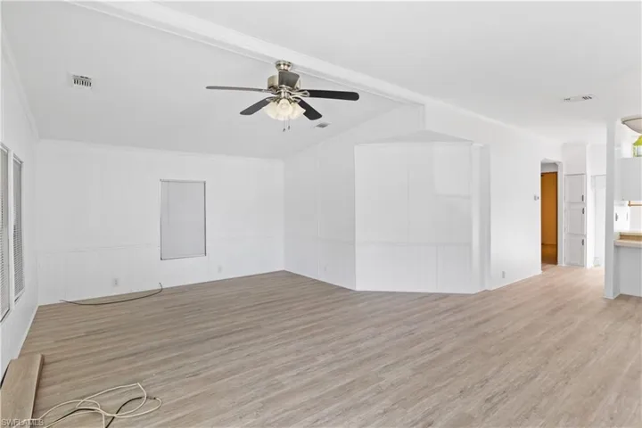Spacious and sun-filled living area with vaulted ceilings and neutral tones, creating an airy and welcoming atmosphere.
