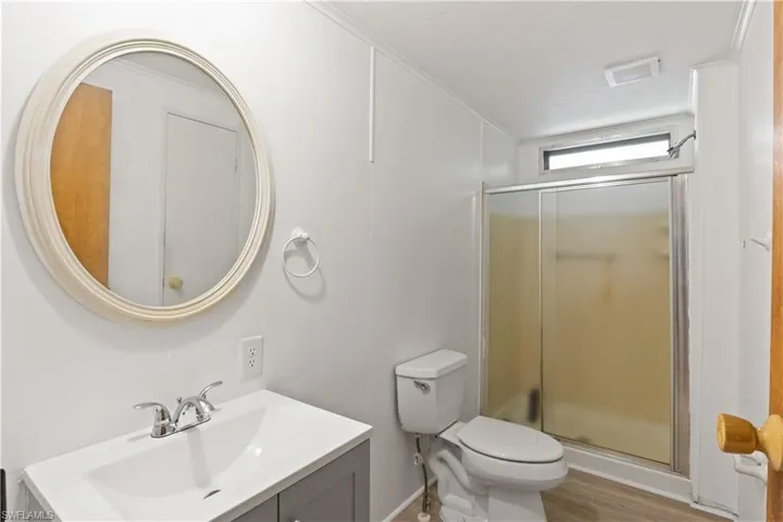 En-suite bathroom featuring a step-in shower and modern vanity.