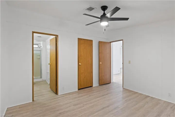 Spacious and bright, the primary bedroom features natural light from large windows and easy-care flooring throughout.