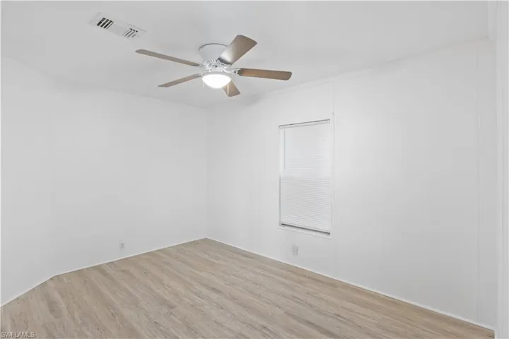 Comfortable guest bedroom with natural light and easy access to the second full bathroom—perfect for visitors or use as an office.
