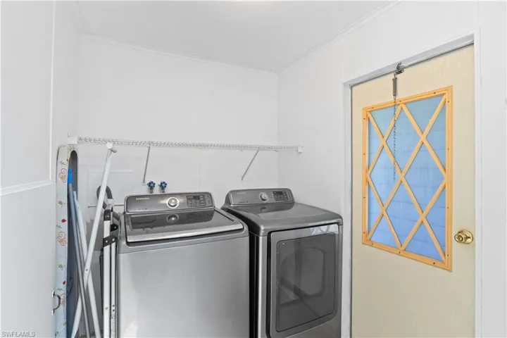 Dedicated laundry area with washer, dryer, and storage to keep things organized and tidy.