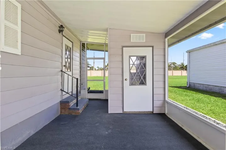 Relax in the screened front lanai—perfect for morning coffee or sunset views in a peaceful, gated community.