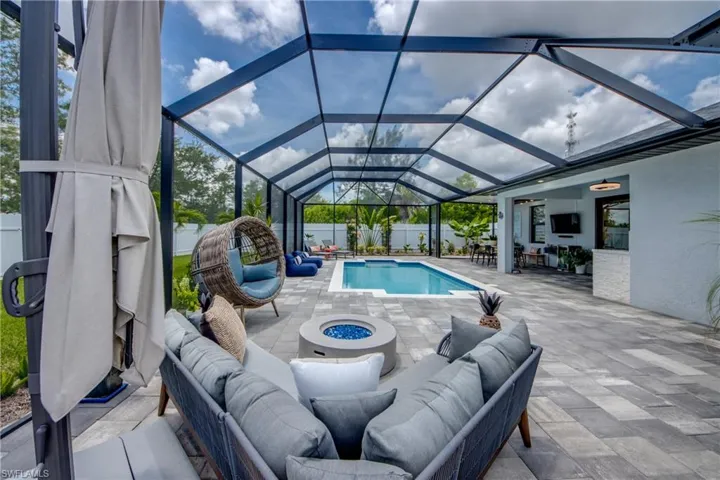 View of pool featuring a lanai, an outdoor hangout area, and a patio area