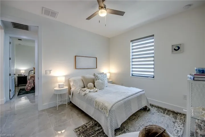 Tiled bedroom with ceiling fan