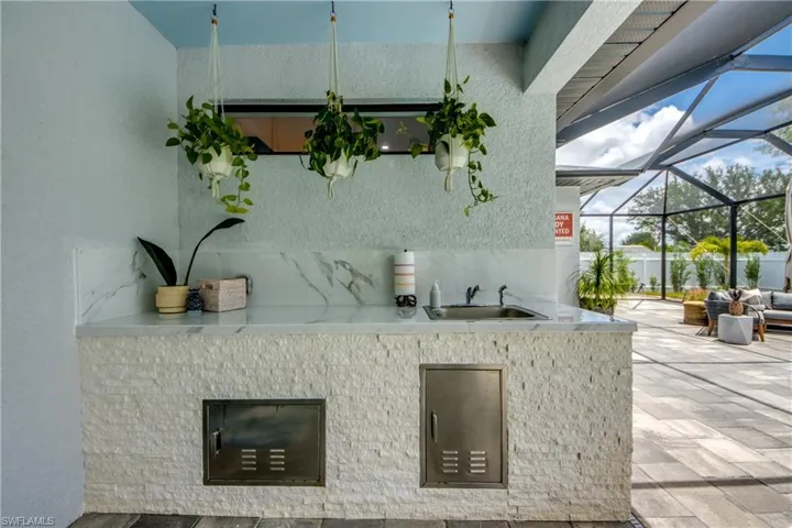 View of patio / terrace with glass enclosure and sink