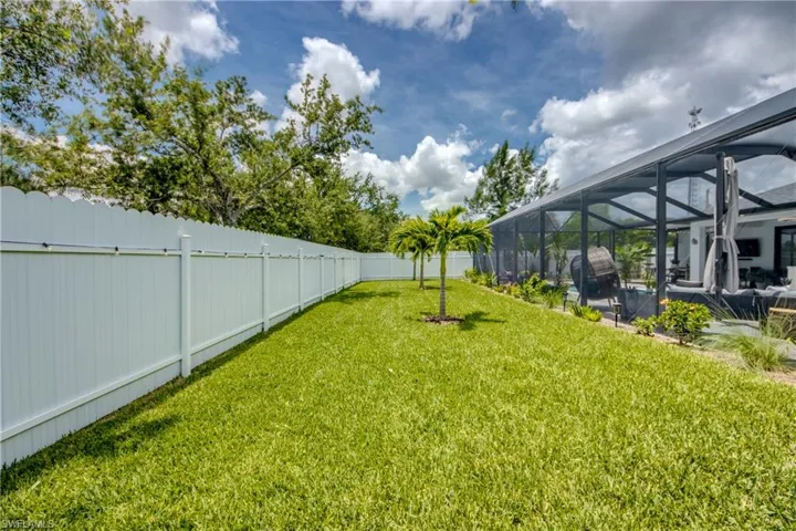 View of yard with glass enclosure