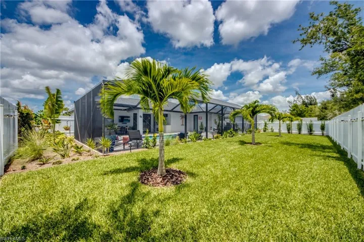 View of yard featuring glass enclosure
