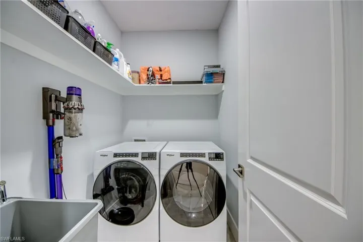 Laundry room with washing machine and dryer, sink, and washer hookup