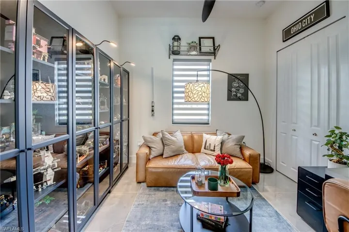 Tiled living room featuring beam ceiling