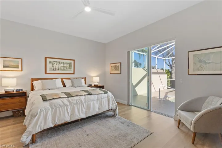 Bedroom featuring ceiling fan, access to outside pool area