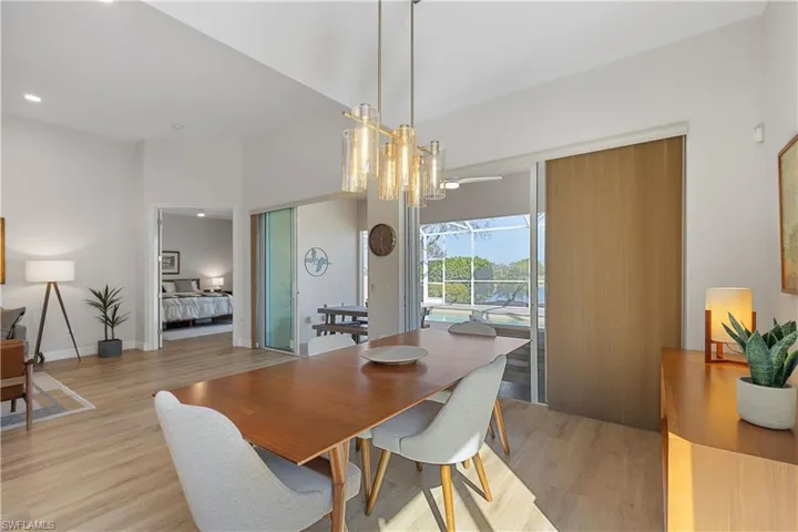 Dining area featuring a notable chandelier and light wood-type flooring