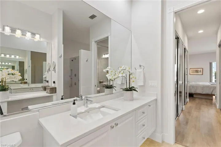Bathroom featuring vanity, wood-type flooring, and an enclosed shower