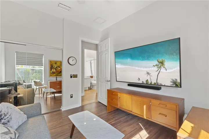 Living room with dark wood-type flooring