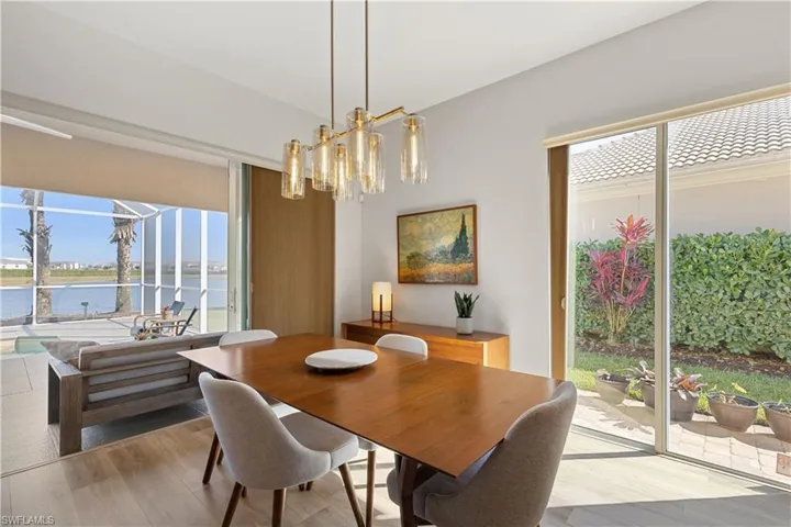 Dining area featuring a water view, a wealth of natural light, and an inviting chandelier