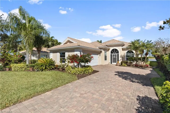 Front of the home with a side loading garage and oversized pavered driveway