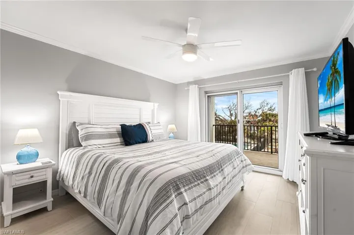 Bedroom featuring ceiling fan, access to exterior, and ornamental molding