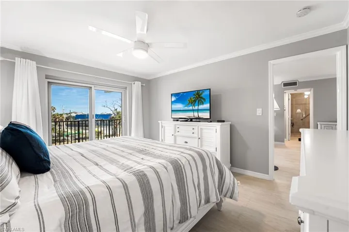 Bedroom with ceiling fan, access to outside, ornamental molding, and light hardwood / wood-style flooring