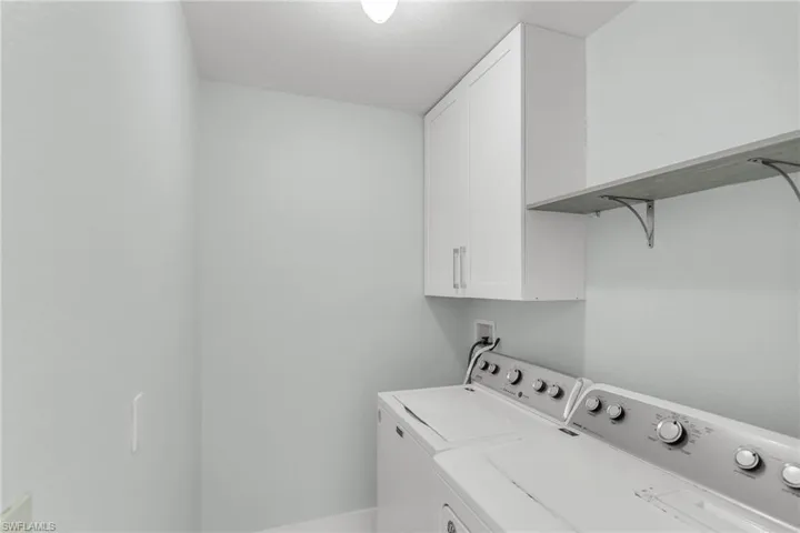 Clothes washing area with cabinets and independent washer and dryer