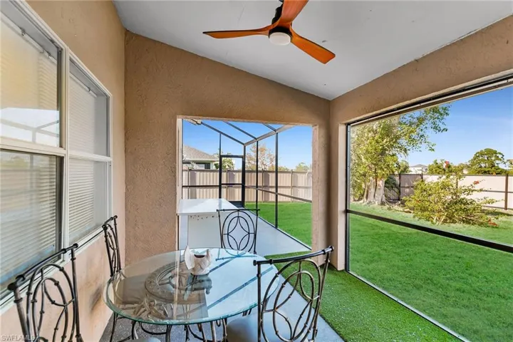Sunroom featuring ceiling fan and lofted ceiling