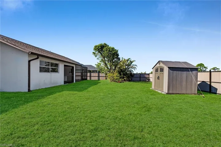 View of yard with a storage unit