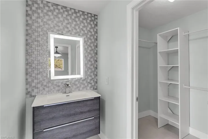 Bathroom with a textured ceiling and vanity