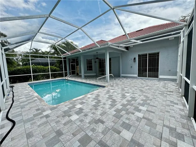 Outdoor pool featuring a patio area and a ceiling fan