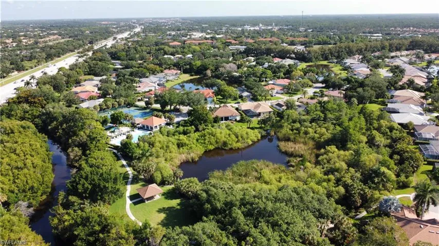 Aerial overview of property's location featuring a nearby body of water and nearby suburban area