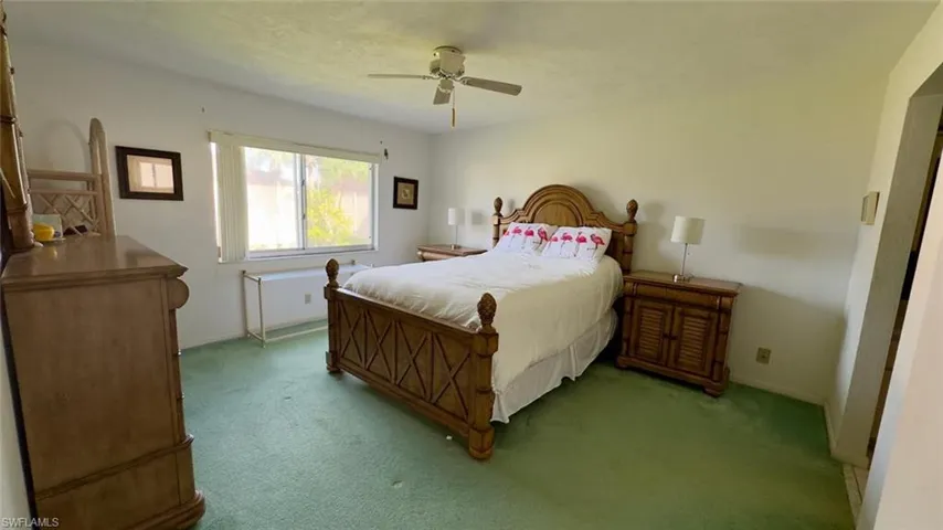 Carpeted bedroom with ceiling fan
