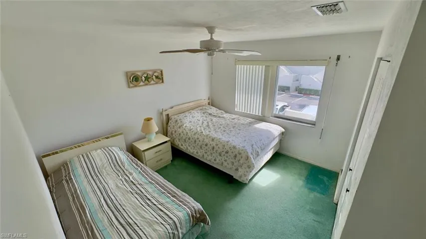 Bedroom with ceiling fan and carpet flooring