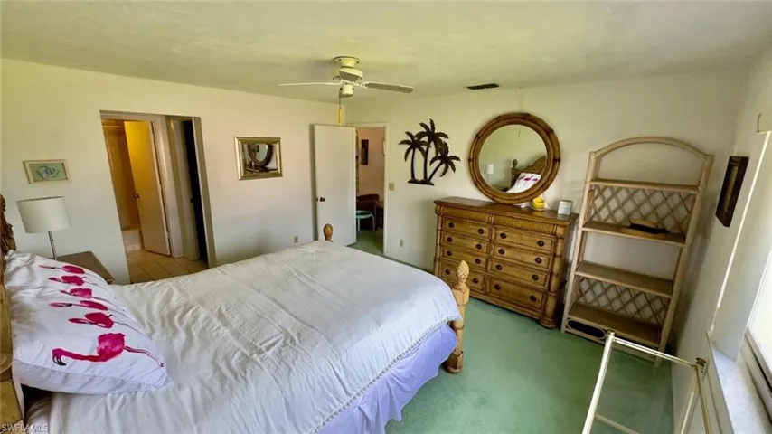 Carpeted bedroom with ceiling fan