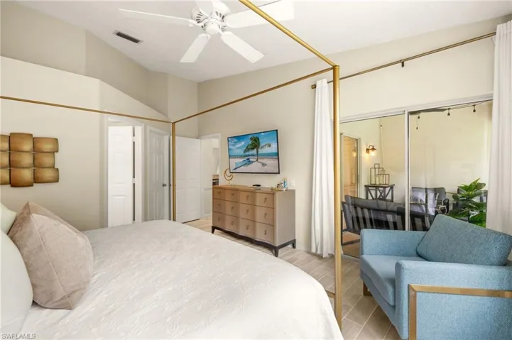 Bedroom with lofted ceiling and a ceiling fan