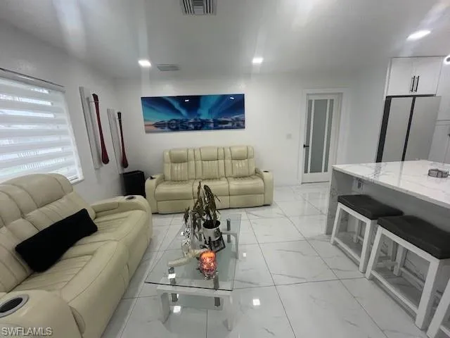 Living area with light marble finish flooring