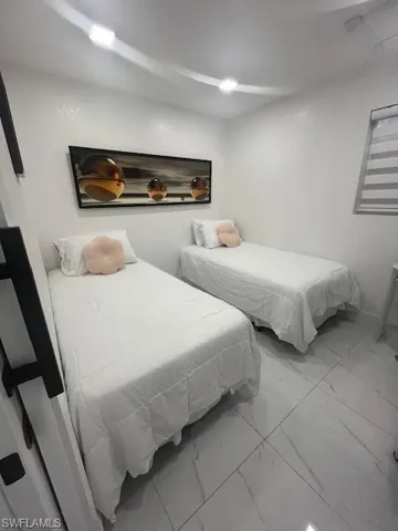 Bedroom with marble finish flooring