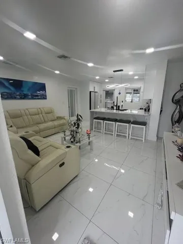 Living area featuring light marble finish flooring