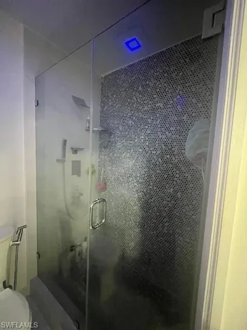 Bathroom with a stall shower and toilet