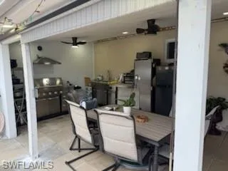 View of patio / terrace featuring a ceiling fan, outdoor dining space, and an outdoor kitchen