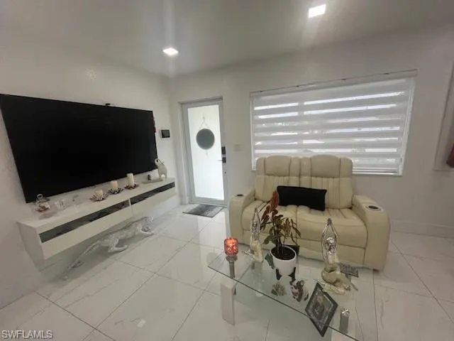 Living room with marble finish floors and baseboards