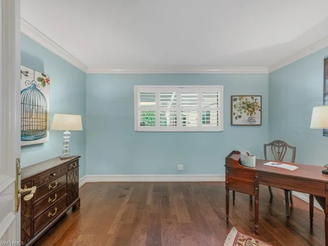 Office featuring dark wood-style floors and crown molding