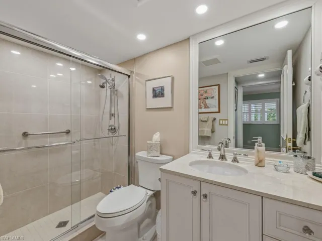 Bathroom featuring vanity, a stall shower, and recessed lighting