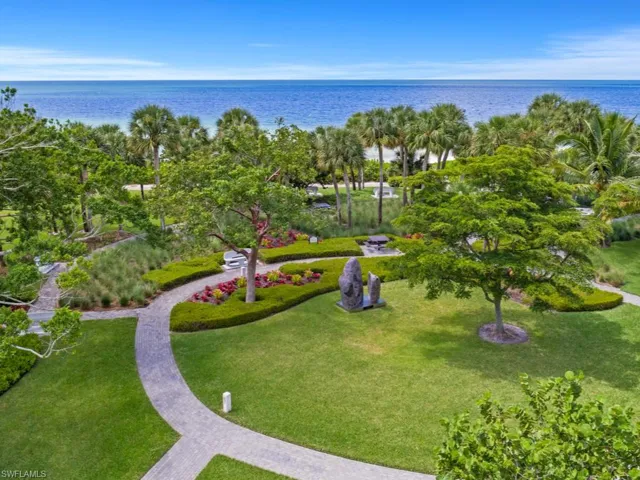 View of home's community featuring a water view and a yard