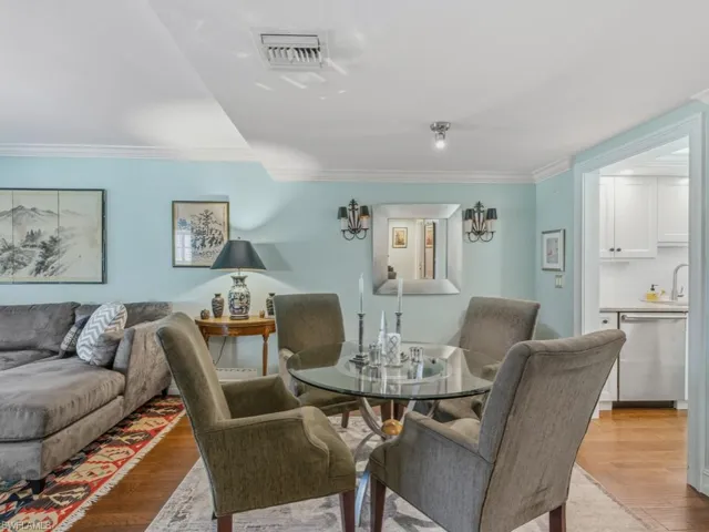 Dining space featuring light wood-style floors and ornamental molding