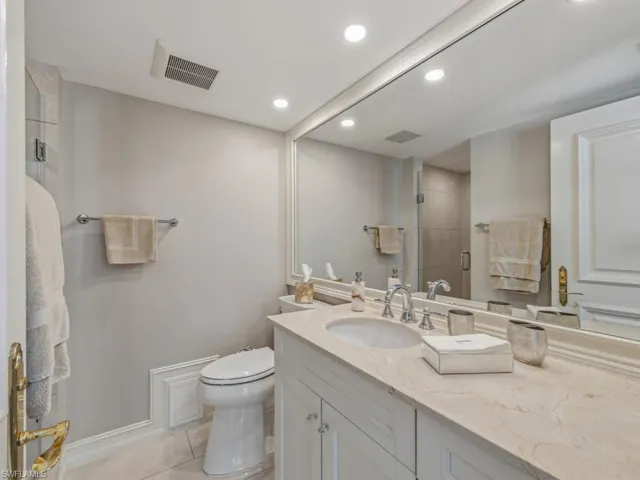 Full bath with a stall shower, vanity, recessed lighting, and light tile patterned floors