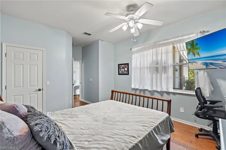 Bedroom with ceiling fan and wood-type flooring