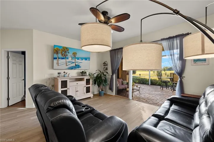 Living room with ceiling fan and light hardwood / wood-style floors