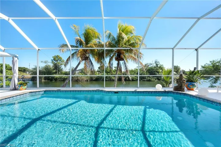 Swimming pool with a sunroom and glass enclosure