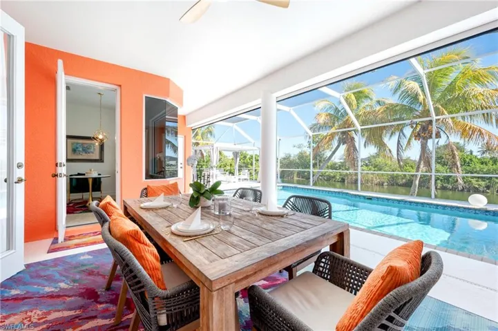 Dining room with a sunroom and a ceiling fan