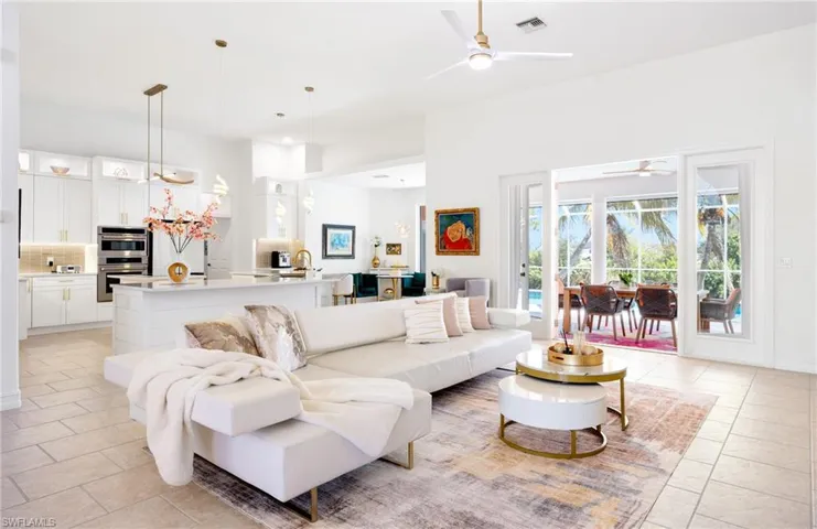 Living room with a ceiling fan and a high ceiling