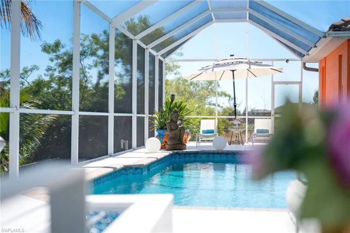 Outdoor pool featuring a lanai, a sunroom, and a patio