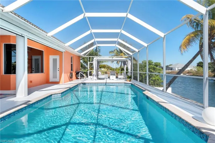 Swimming pool featuring a lanai, a patio, and a sunroom